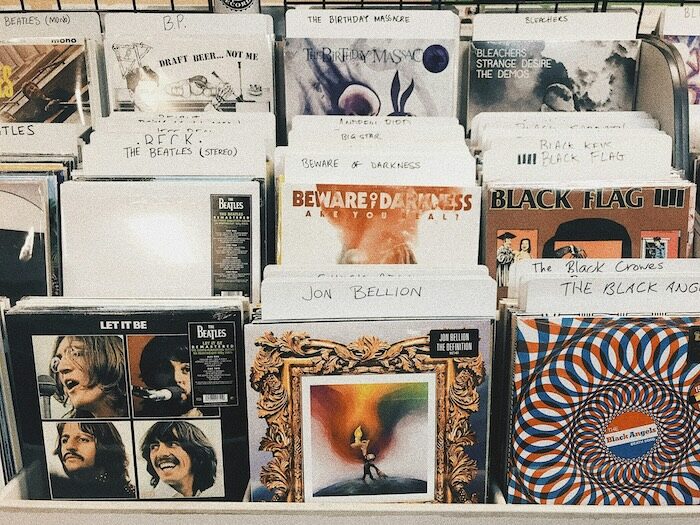 A range of vinyl record covers in a shop