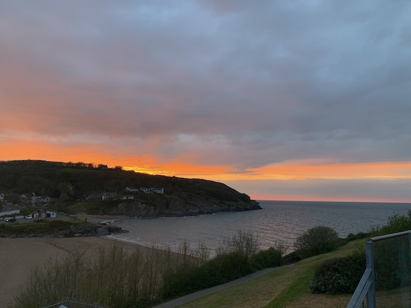 a sunset over a bay in west wales
